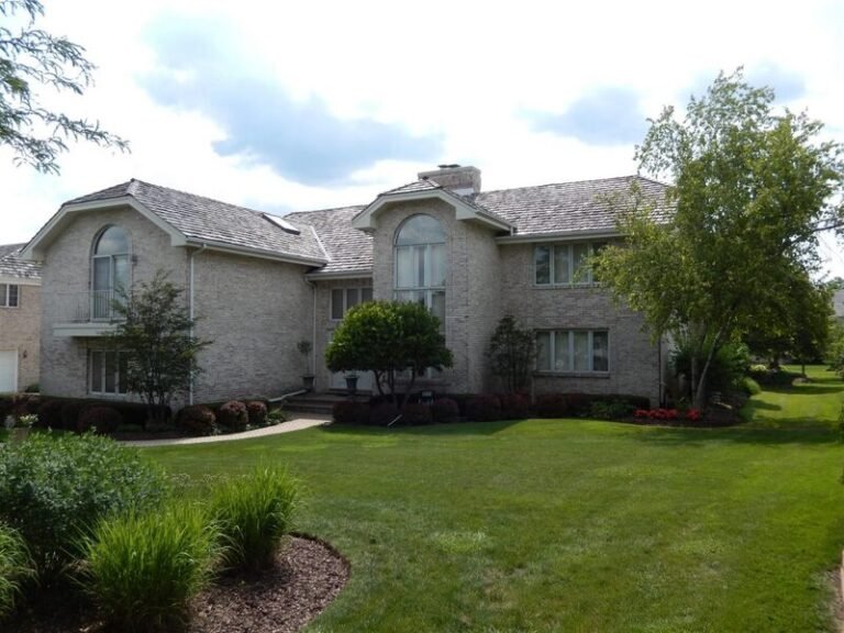 Cedar shake roof on a two-story home, installed by Adept Construction