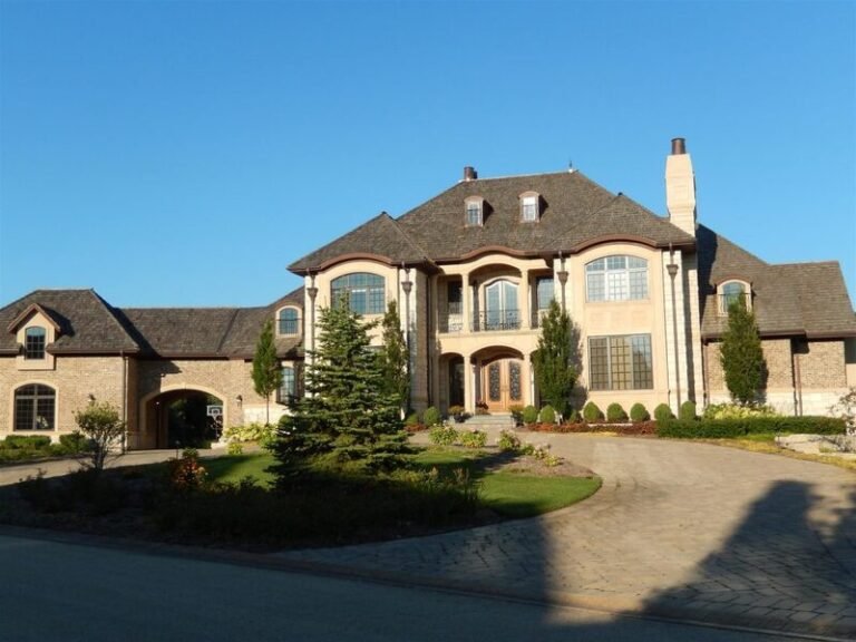 Cedar shake roof on a stone-front home, installed by Adept Construction