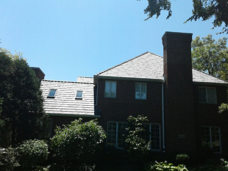 Composite slate-look roof on a brick home, installed by Adept Construction