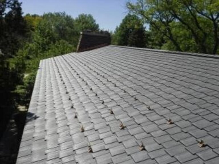Composite roof along a ridge line, installed by Adept Construction