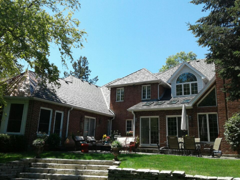 Composite roof on a two-story home, installed by Adept Construction