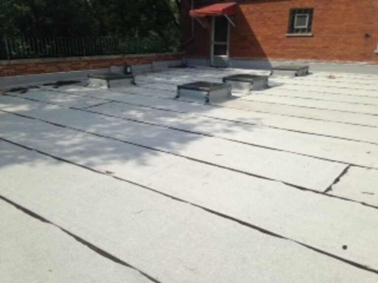 Large flat commercial roof with seamed membrane, installed by Adept Construction