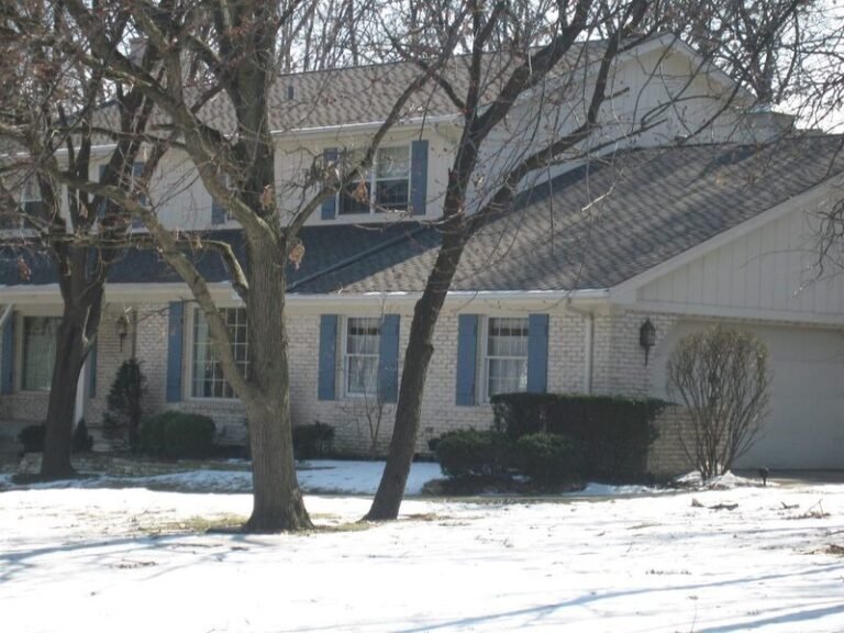 New gutters on a two-story home, installed by Adept Construction