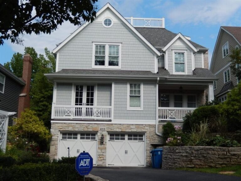 Roofing project by Adept Construction on a white two-story colonial home