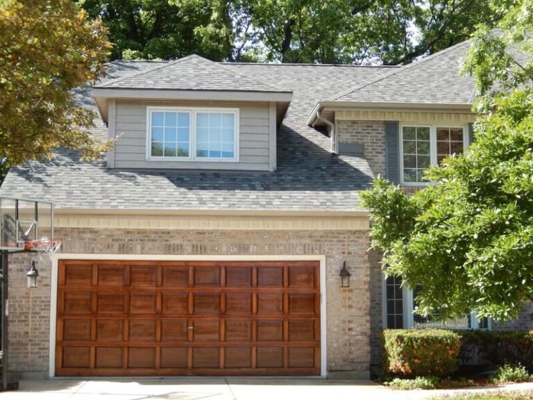 Roofing project by Adept Construction on a home with a dormer above the garage