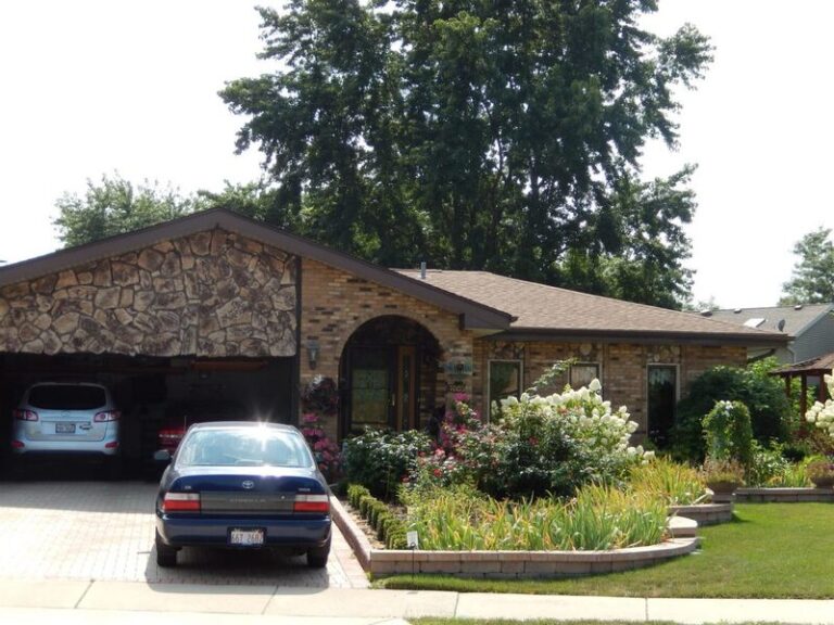 Roofing project by Adept Construction on a brick ranch home with an attached garage