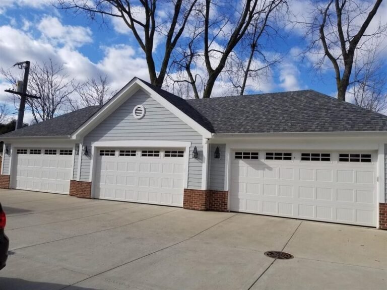 Roofing project by Adept Construction on a home with a three-car garage