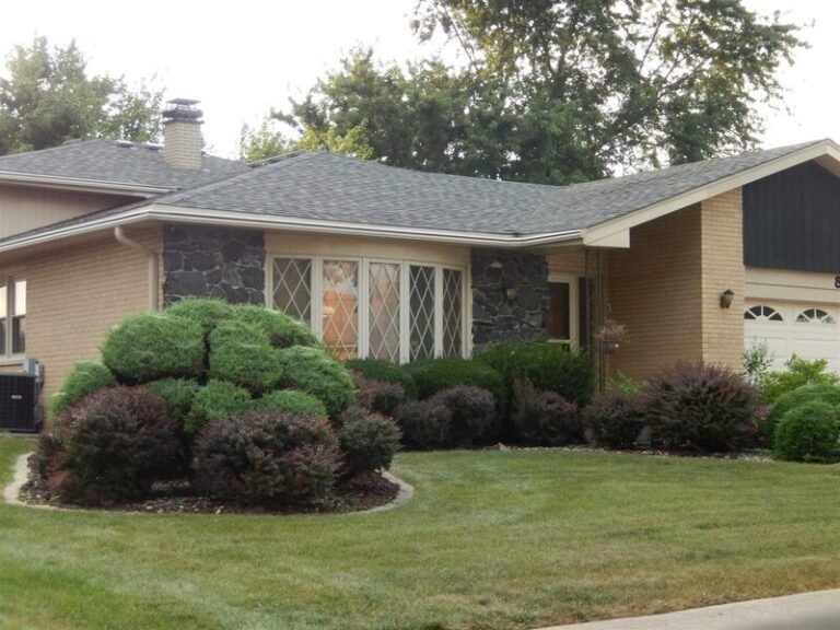 Roofing project by Adept Construction on a split-level home with a brown shingle roof