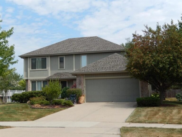 Roofing project by Adept Construction on a two-story home with a gray shingle roof
