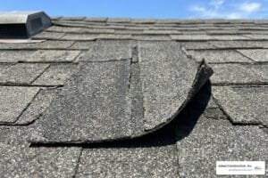 damaged asphalt shingle on a residential roof