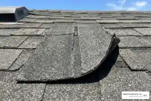 damaged asphalt shingle on a residential roof