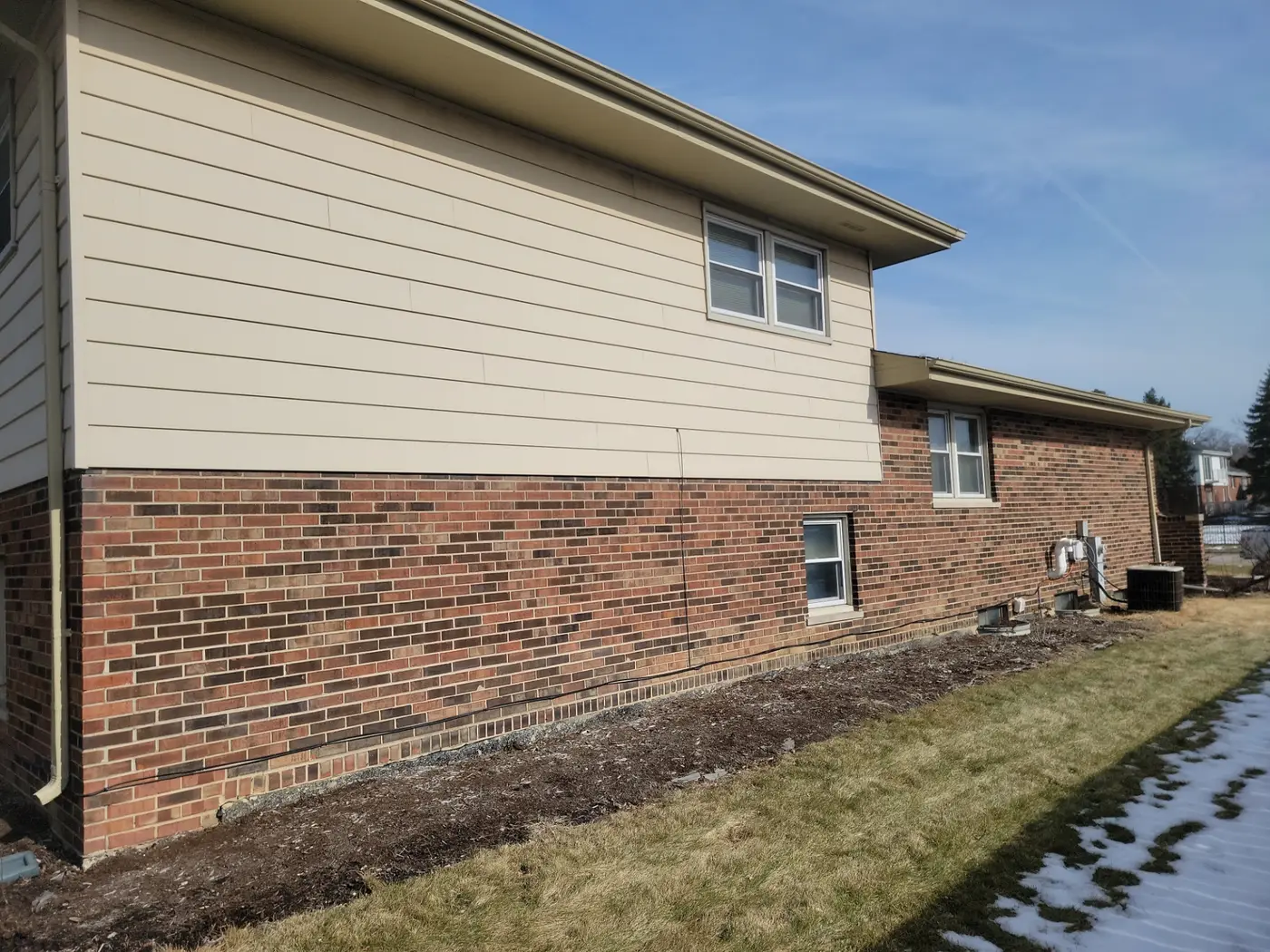 New gutters and fascia on the side of a Downers Grove, IL split-level