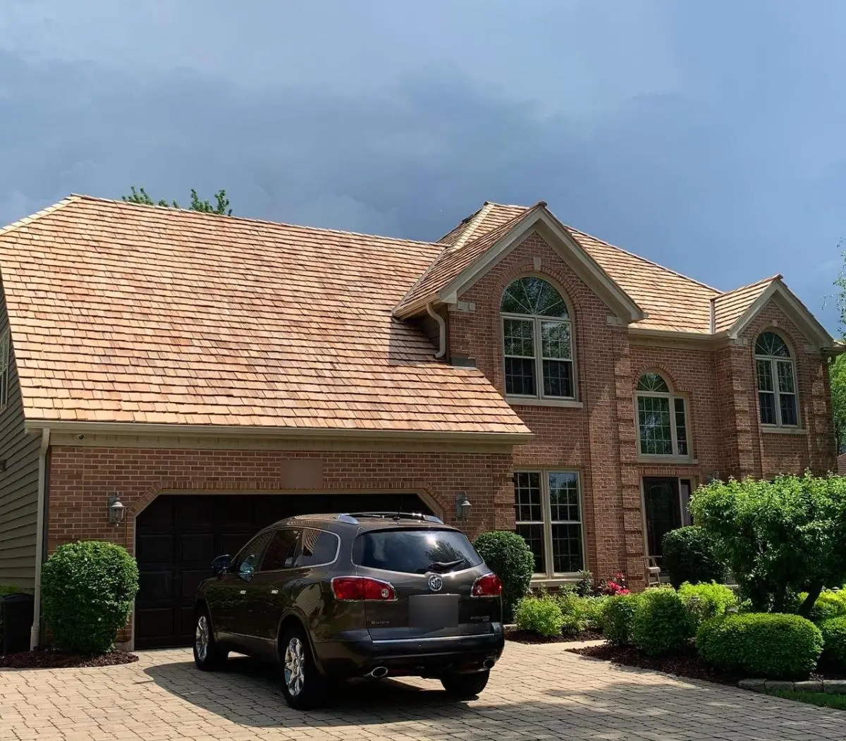 Natural cedar shake roof on a brick two-story home in Naperville, IL