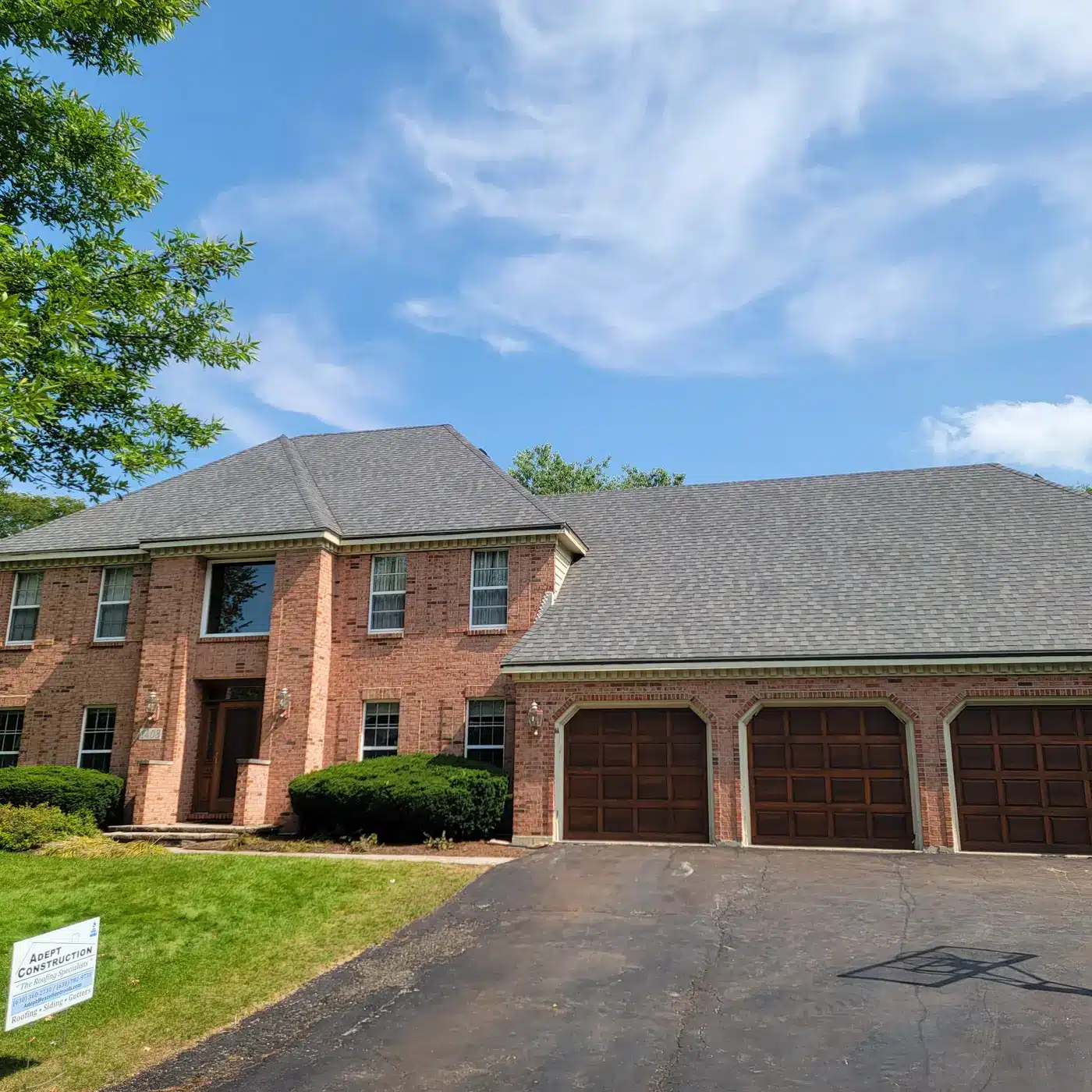 Completed roof replacement on a brick colonial in Naperville, IL