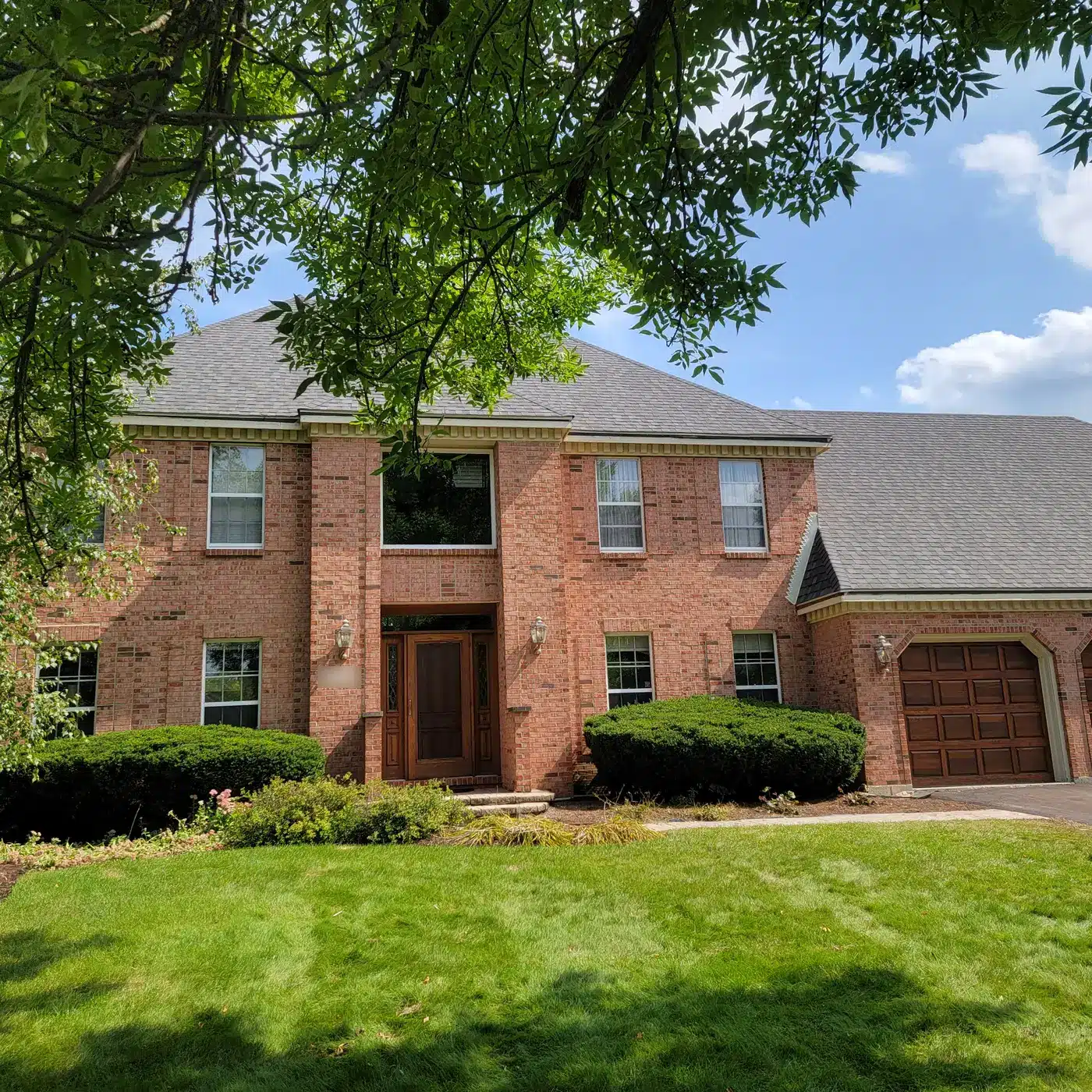 Completed roof replacement on a brick home in Naperville, IL